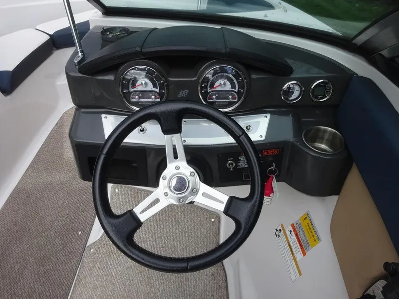 Slide: The Image of 2013 Four Winns Horizon 200 boat dashboard with steering wheel and gauges. - 11