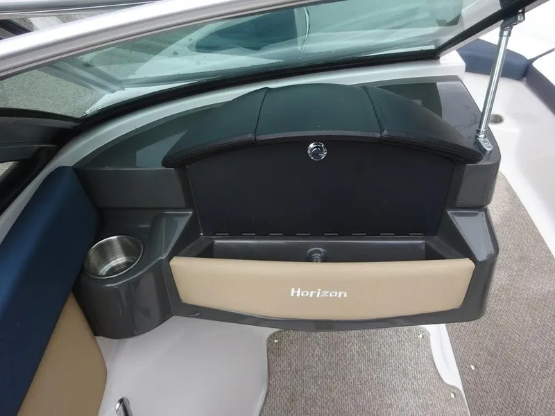 Slide: The Image of 2013 Four Winns Horizon 200 boat interior with storage compartment and cup holder. - 12
