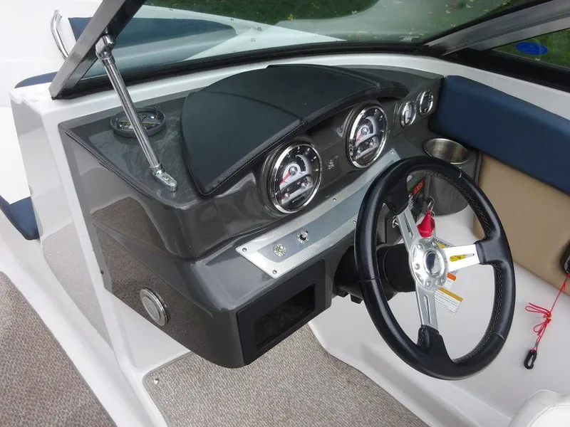 Slide: The Image of 2013 Four Winns Horizon 200 dashboard with steering wheel and gauges. - 13