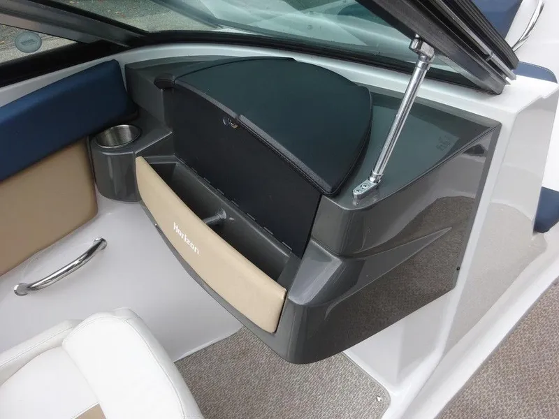 Slide: The Image of 2013 Four Winns Horizon 200 boat interior with storage compartment and cup holder. - 14