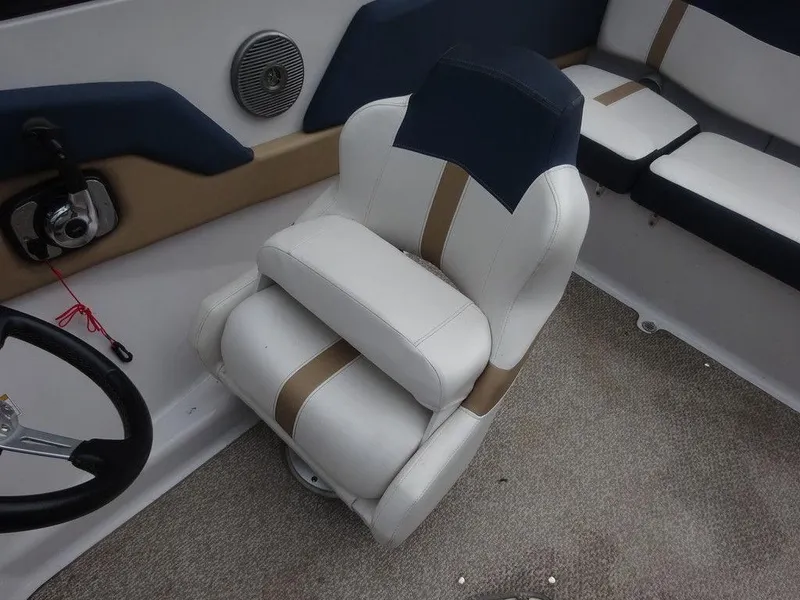 Slide: The Image of 2013 Four Winns Horizon 200 boat interior with cushioned seating and steering wheel. - 7