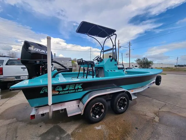 Slide: The Image of 2024 Majek Boats 21 RFL on trailer, turquoise and black design, Suzuki outboard motor. - 2