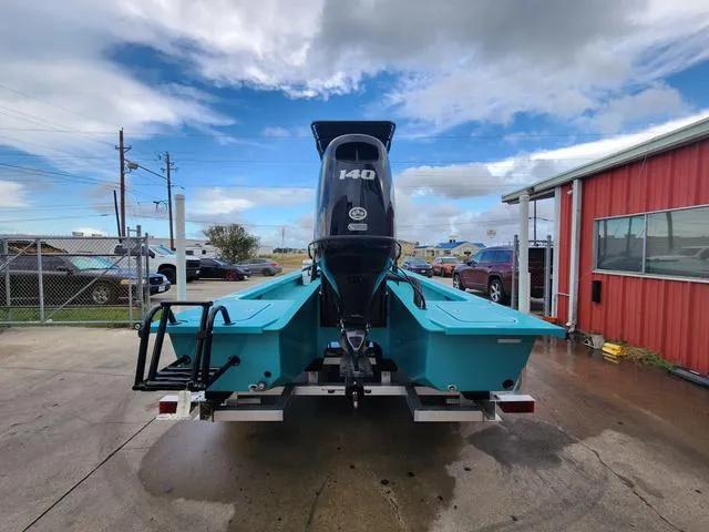 Slide: The Image of 2024 Majek Boats 21 RFL with 140 HP engine, parked outdoors. - 3