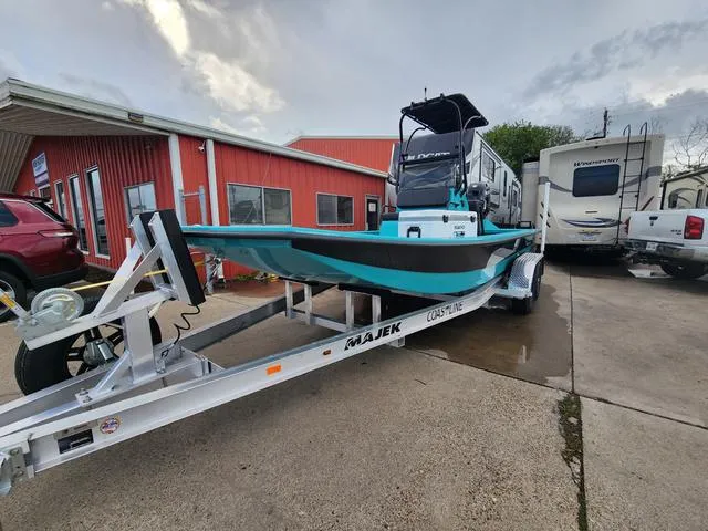 Slide: The Image of 2024 Majek Boats 21 RFL on trailer, parked outside red building. - 6