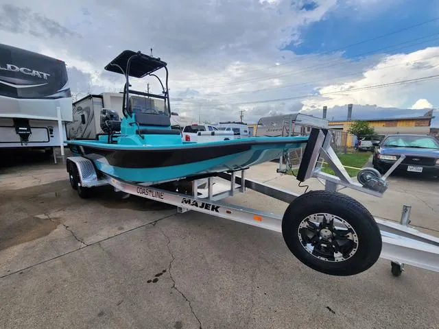 Slide: The Image of 2024 Majek Boats 21 RFL on trailer, vibrant blue and black design, parked outdoors. - 7