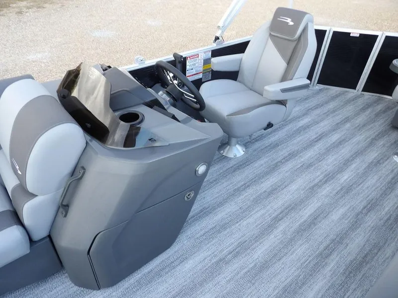 Slide: The Image of 2025 Bennington 21 SL boat interior with gray seating and steering console. - 18