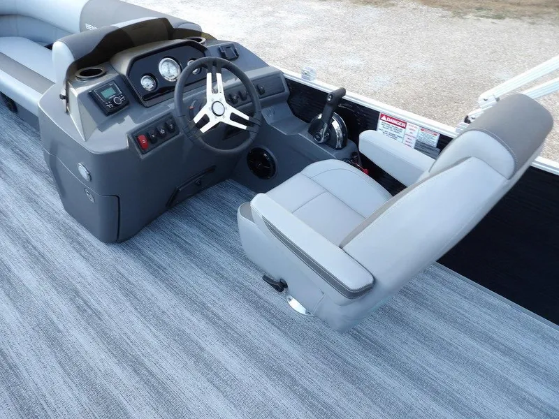 Slide: The Image of 2025 Bennington 21 SL boat interior with gray captain's chair and control panel. - 19