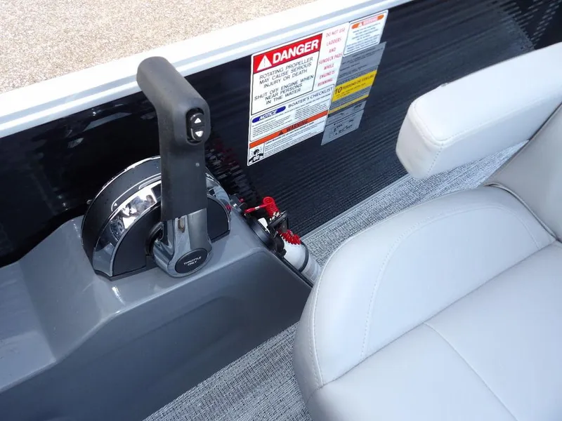 Slide: The Image of Control panel and seat of 2025 Bennington 21 SL boat with safety warnings. - 28