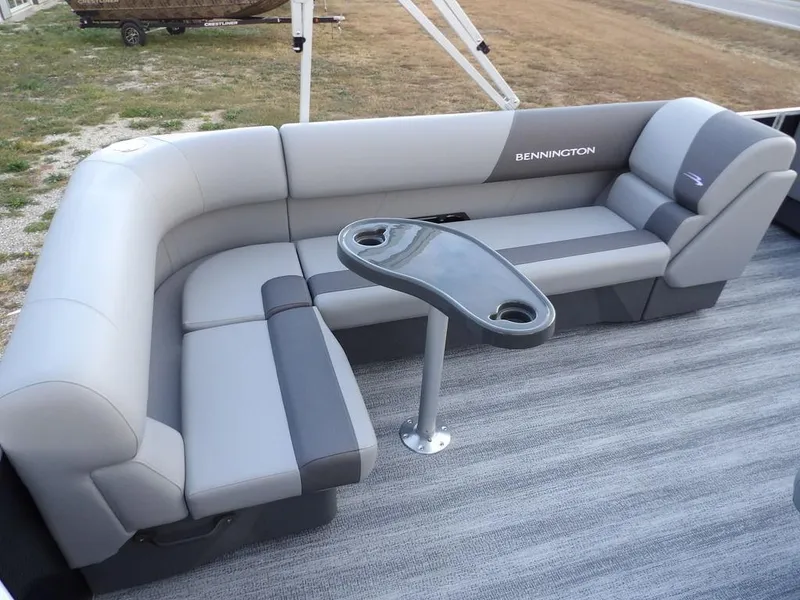 Slide: The Image of 2025 Bennington 21 SL pontoon boat interior with gray seating and table. - 30