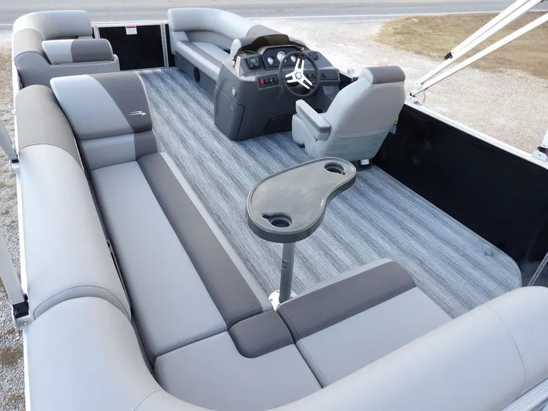 Slide: The Image of 2025 Bennington 21 SL pontoon boat interior with gray seating and steering console. - 34