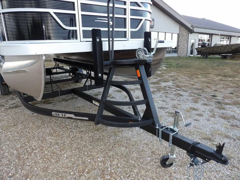 Slide: The Image of 2025 Bennington 21 SL pontoon boat on trailer, parked outdoors. - 41