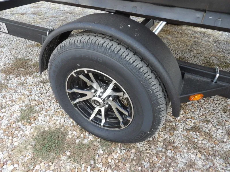 Slide: The Image of 2025 Bennington 21 SL trailer wheel on gravel surface. - 43