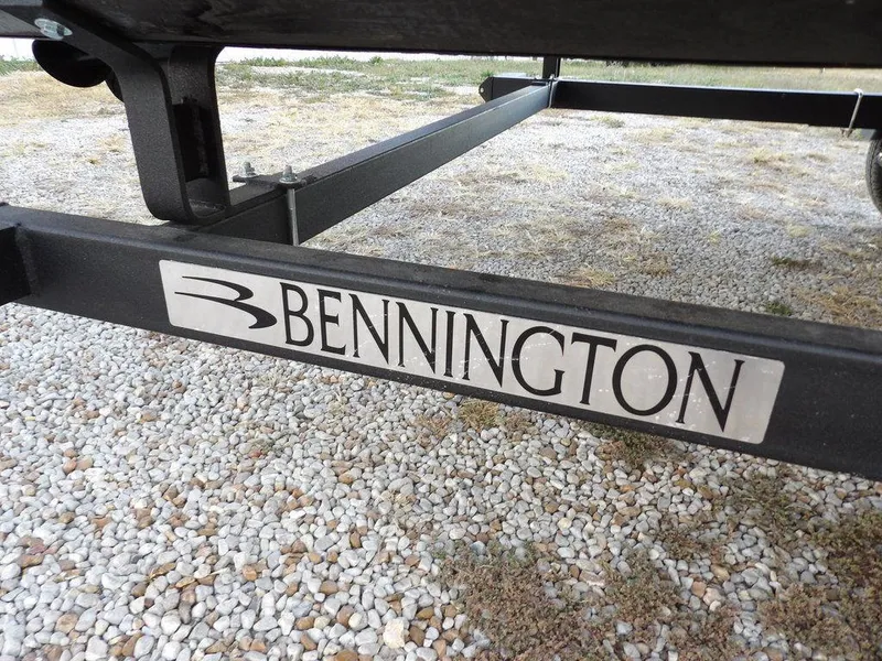 Slide: The Image of Bennington 21 SL 2025 boat trailer on gravel surface. - 44
