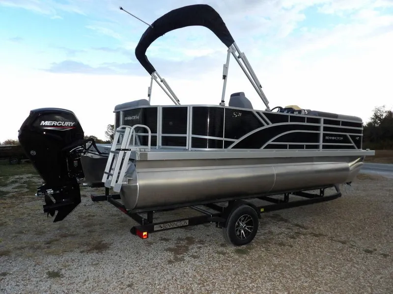 Slide: The Image of 2025 Bennington 21 SL pontoon boat with Mercury outboard engine on trailer. - 7
