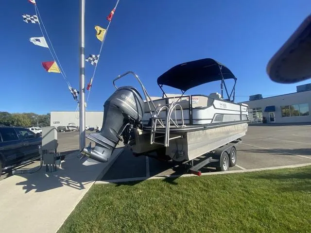 Slide: The Image of 2022 G3 SL boat on trailer with outboard motor, parked outdoors under clear blue sky. - 4