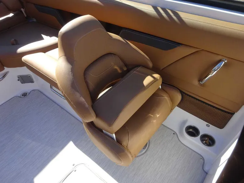 Slide: The Image of 2025 Four Winns HD 5 Sterndrive boat interior with brown leather seating. - 12
