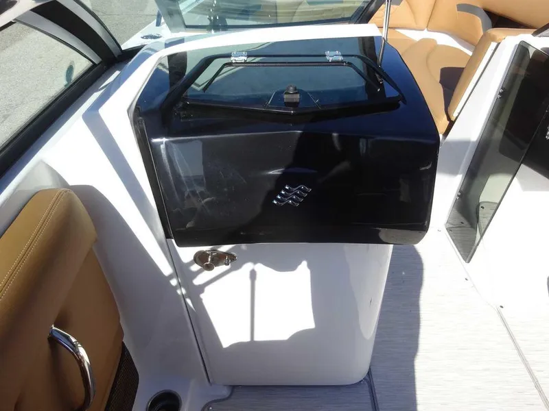 Slide: The Image of 2025 Four Winns HD 5 Sterndrive boat interior with sleek black console. - 15