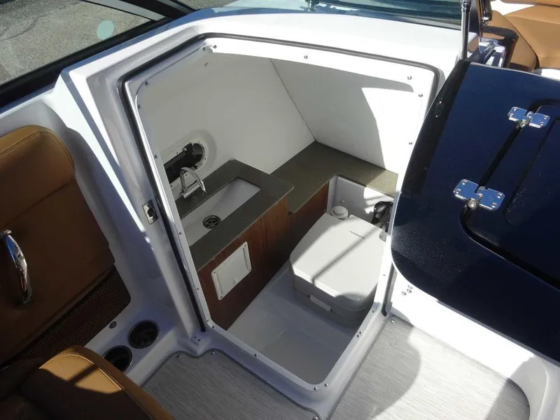 Slide: The Image of Interior of 2025 Four Winns HD 5 Sterndrive boat with compact bathroom amenities. - 16