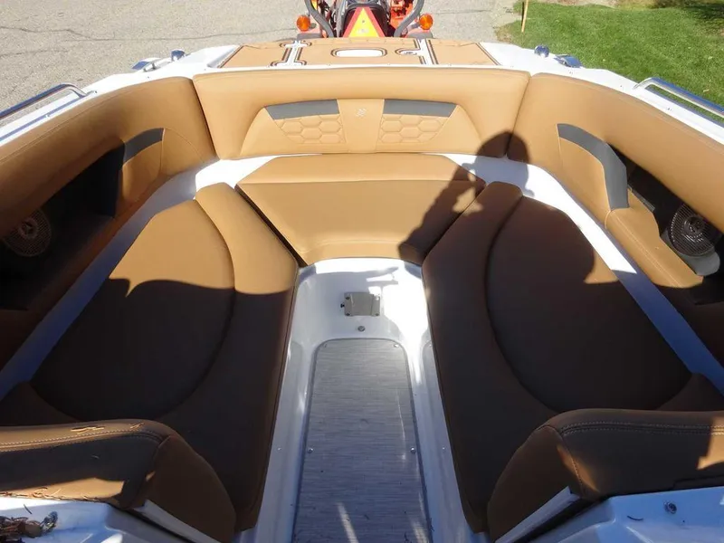 Slide: The Image of 2025 Four Winns HD 5 Sterndrive boat interior with tan seating and modern design. - 18