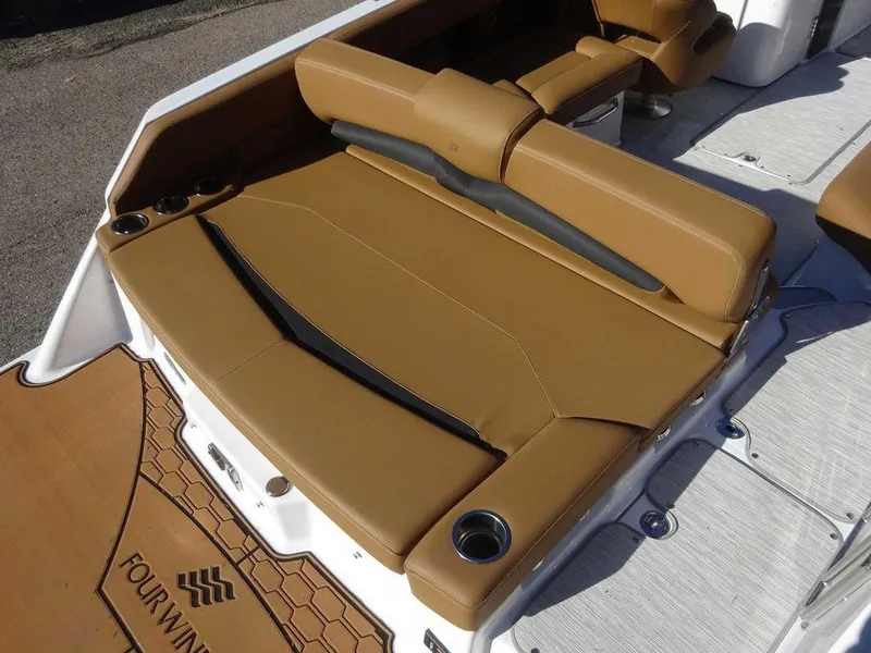 Slide: The Image of 2025 Four Winns HD 5 Sterndrive boat with tan leather seating and cup holders. - 20