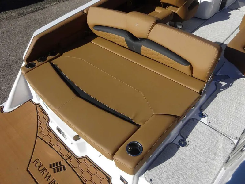 Slide: The Image of 2025 Four Winns HD 5 Sterndrive boat with tan leather seating and cup holders. - 21
