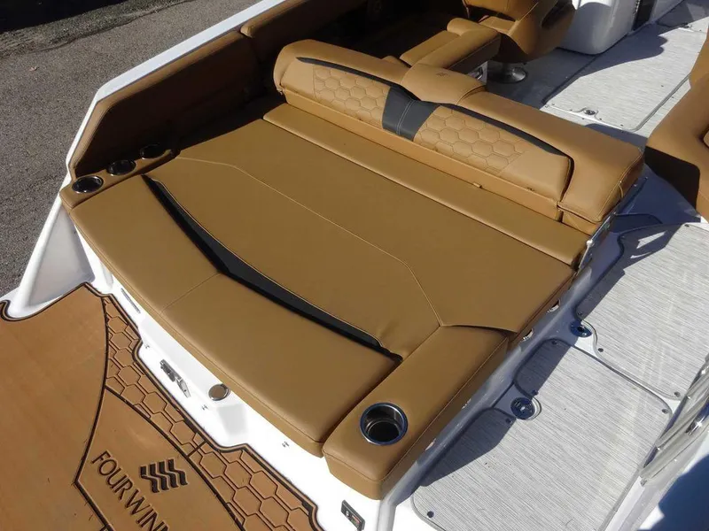 Slide: The Image of 2025 Four Winns HD 5 Sterndrive boat with tan seating and cup holders. - 23