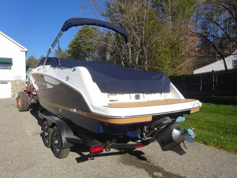 Slide: The Image of 2025 Four Winns HD 5 Sterndrive boat on trailer, parked outdoors. - 3