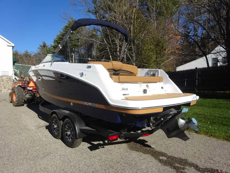 Slide: The Image of 2025 Four Winns HD 5 Sterndrive boat on trailer, parked outdoors. - 5