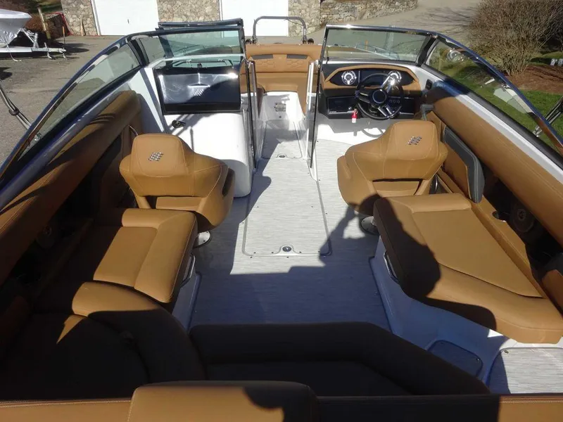 Slide: The Image of 2025 Four Winns HD 5 Sterndrive boat interior with tan seating and modern dashboard. - 6