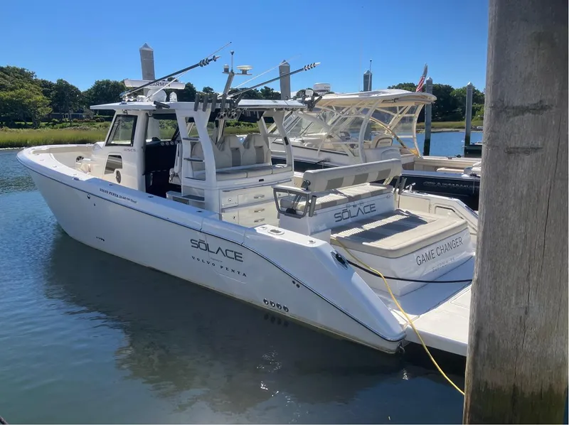 The Image of Luxury 2022 Solace 415 boat docked in a serene marina setting. - 0