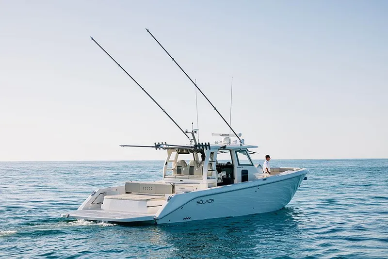 Slide: The Image of 2022 Solace 415 boat cruising on open water under clear skies. - 2