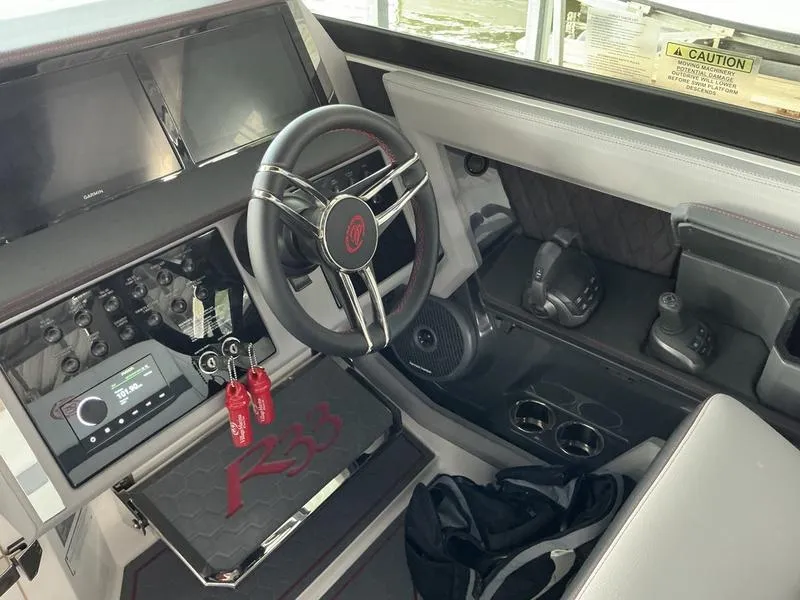Slide: The Image of Interior of 2025 Cobalt R33 Surf boat with seating, storage, and fire extinguisher. - 11