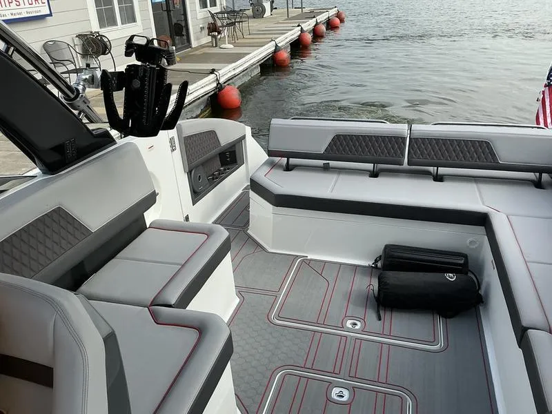 Slide: The Image of Control panel of 2025 Cobalt R33 Surf boat with various switches and radio display. - 4