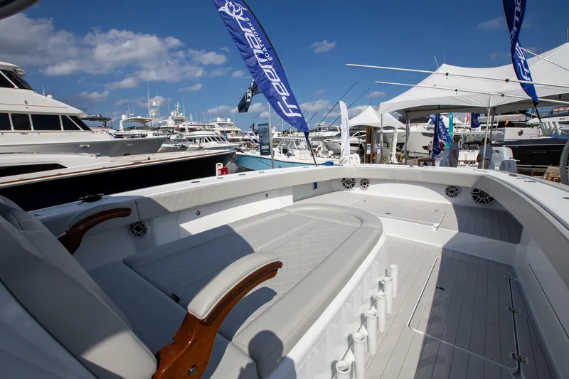 Slide: The Image of Freeman 47 boat at marina, 2023 model, with luxury seating and banners. - 11