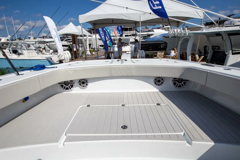 Slide: The Image of 2023 Freeman 47 boat deck at a marina, showcasing spacious design and modern features. - 12
