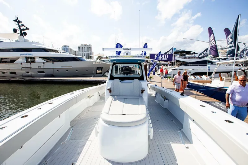 Slide: The Image of 2023 Freeman 47 boat at marina with yachts and visitors. - 13