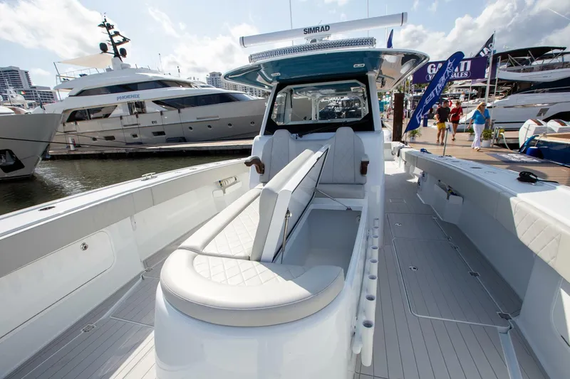 Slide: The Image of 2023 Freeman 47 boat interior at marina, showcasing seating and deck features. - 14