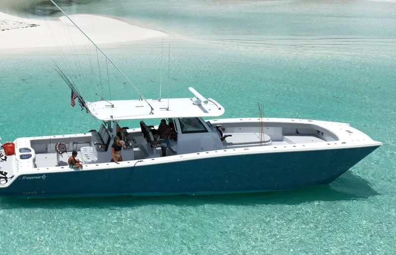 Slide: The Image of Freeman 47 boat cruising in clear turquoise waters, 2023 model. - 2