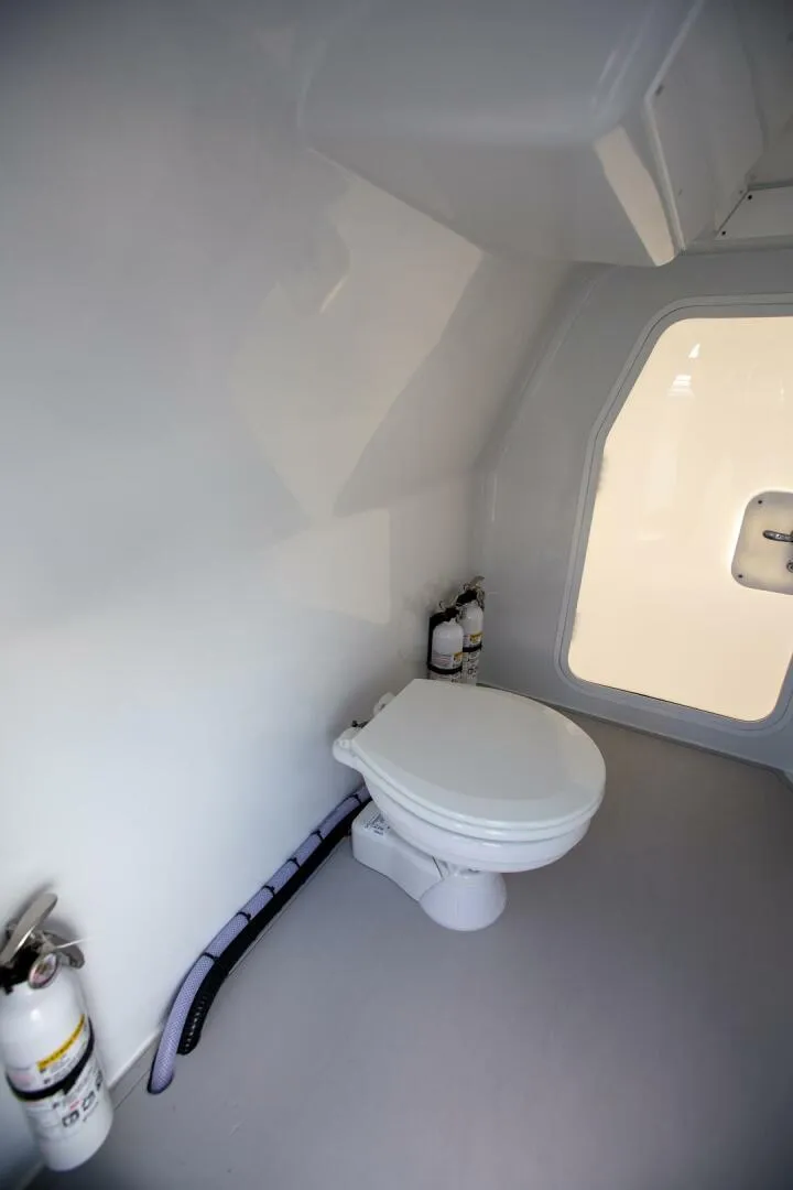 Slide: The Image of Freeman 47 boat interior bathroom with toilet and fire extinguisher, 2023 model. - 23