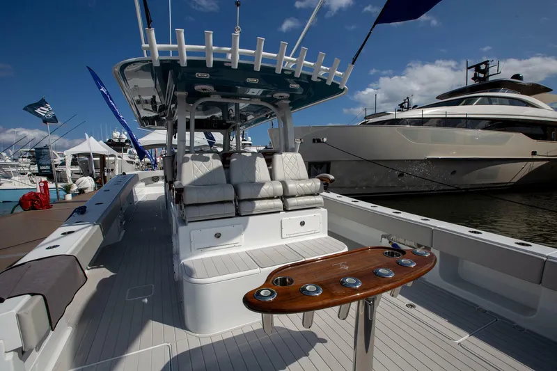 Slide: The Image of 2023 Freeman 47 boat interior with seating and rod holders at a marina. - 5
