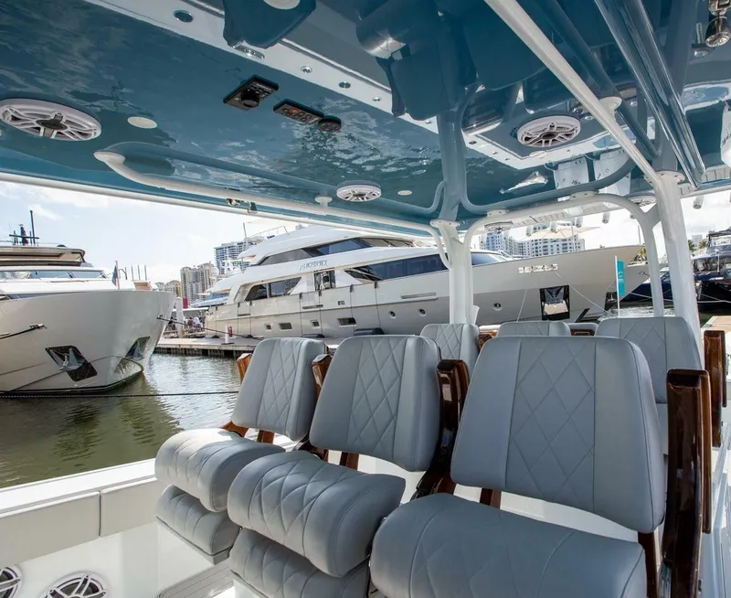 Slide: The Image of Interior of 2023 Freeman 47 boat with luxury seating, docked near yachts. - 9