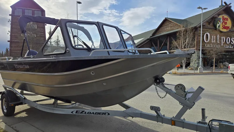 Slide: The Image of 2024 Spartan 185 Astoria boat on trailer outside outdoor store. - 3