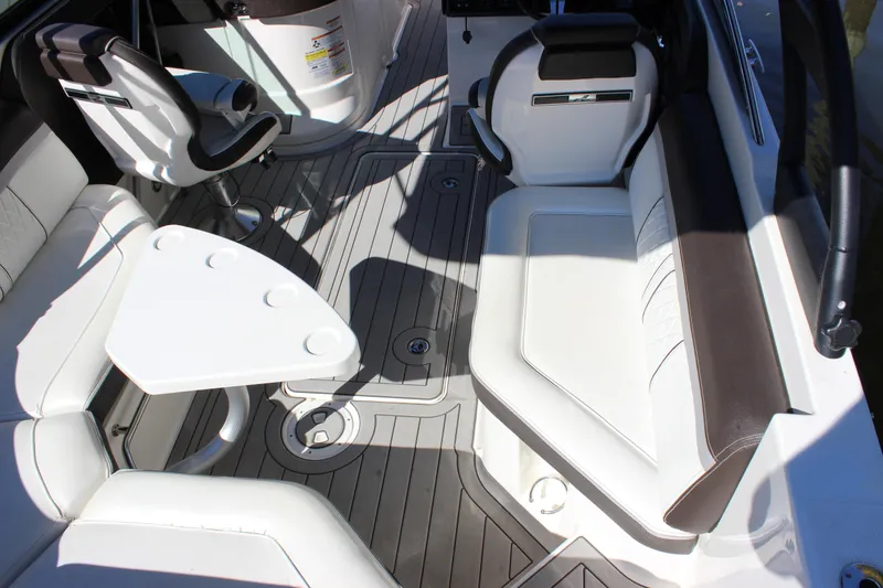 Slide: The Image of 2016 Sea Ray 250 SLX boat interior with white seating and table. - 10