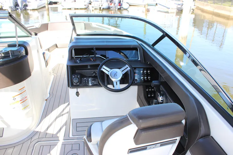 Slide: The Image of 2016 Sea Ray 250 SLX boat cockpit with steering wheel and controls. - 12