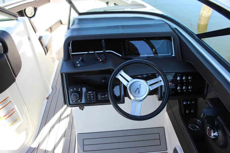 Slide: The Image of 2016 Sea Ray 250 SLX boat dashboard with steering wheel and control panel. - 13