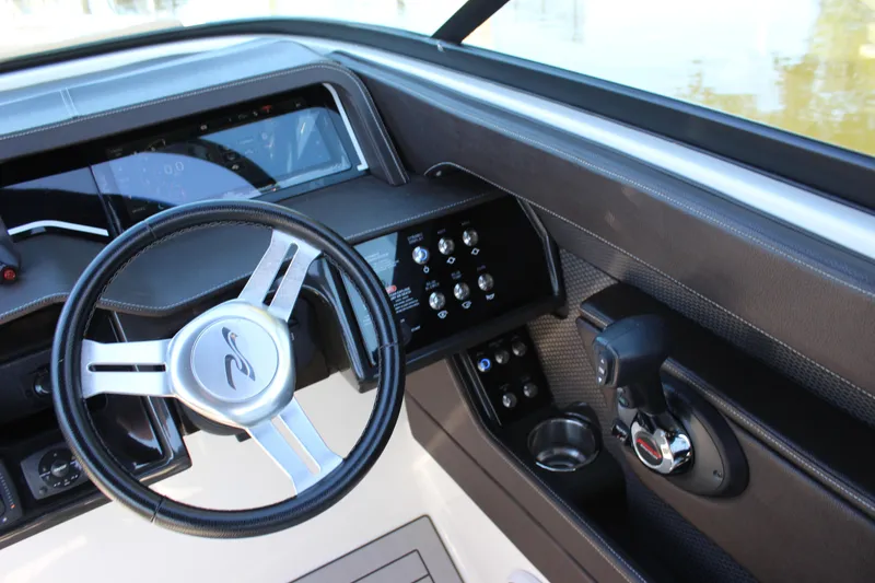 Slide: The Image of 2016 Sea Ray 250 SLX boat dashboard with steering wheel and control panel. - 16