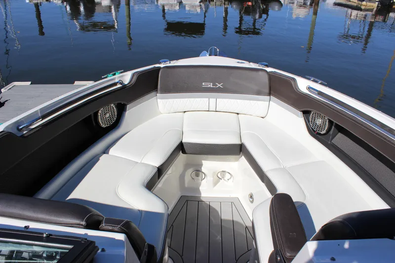 Slide: The Image of 2016 Sea Ray 250 SLX boat interior with white seating and cup holders. - 17