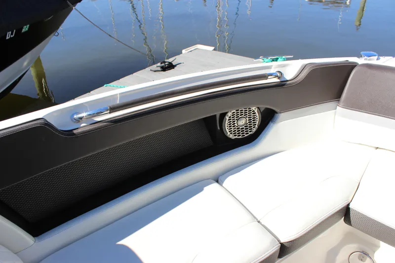 Slide: The Image of 2016 Sea Ray 250 SLX boat interior with cushioned seating and speaker. - 19