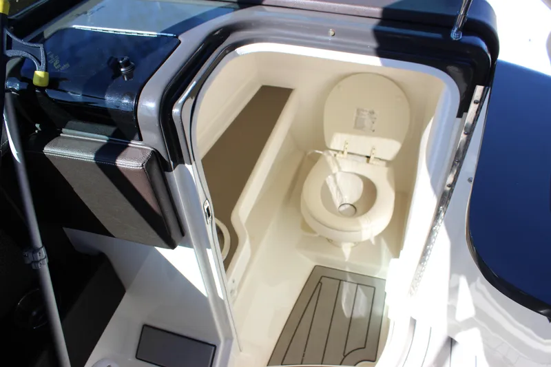 Slide: The Image of 2016 Sea Ray 250 SLX boat interior with compact marine toilet. - 21