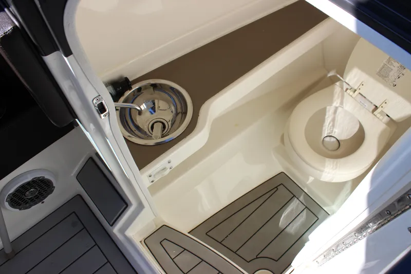 Slide: The Image of 2016 Sea Ray 250 SLX boat interior with sink and toilet. - 23
